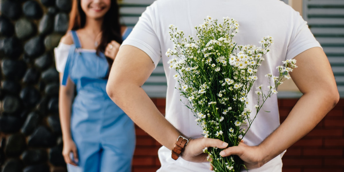 man holding flowers for girlfriend