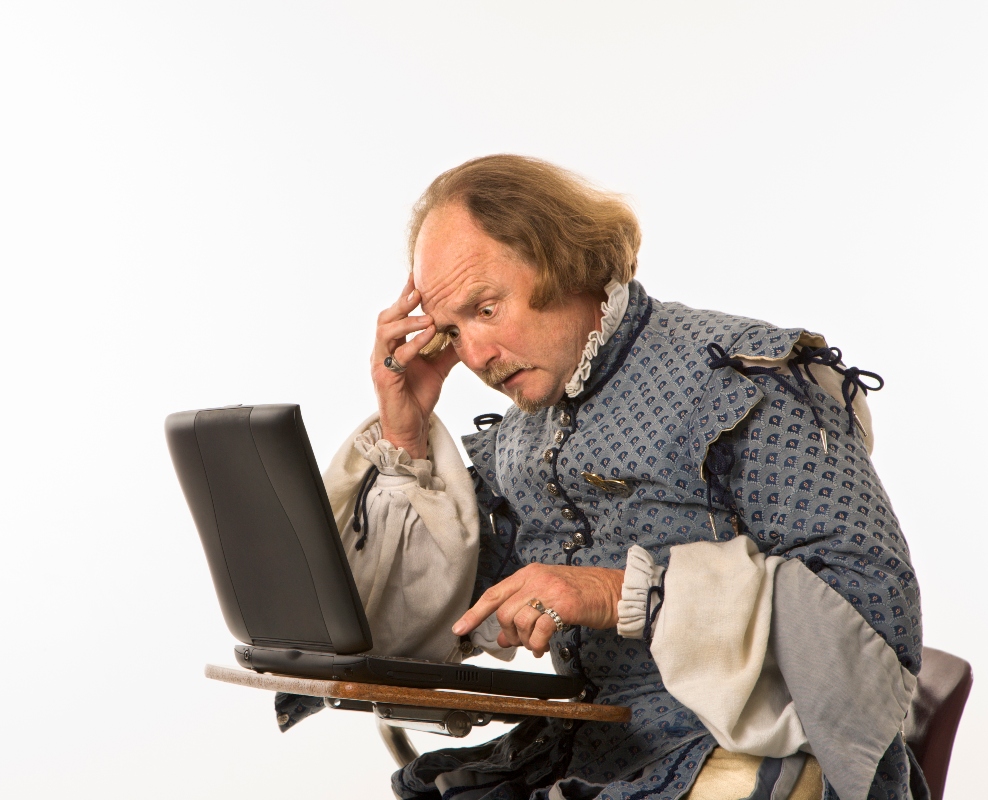 shakespearean man on a laptop looking confused