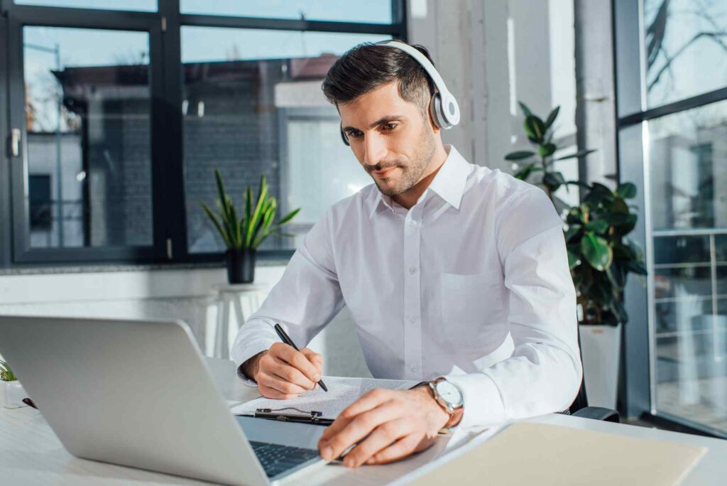man wearing a headset and translating a document